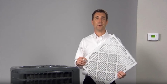 A man holding AC filter